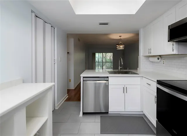 a kitchen with a sink and a stove top oven