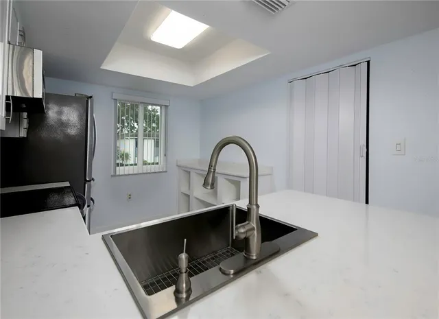 a kitchen with a refrigerator and a sink