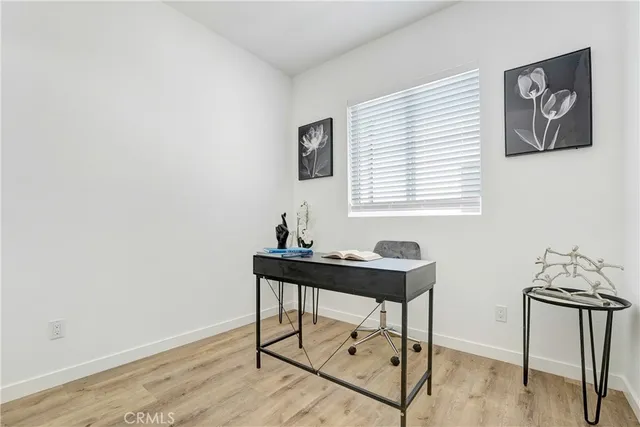 a view of a workspace with furniture and wooden floor
