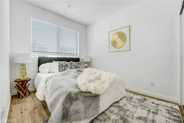 a bedroom with a bed and painting on the wall