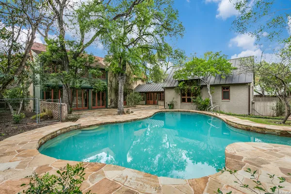 a swimming pool with outdoor seating and yard