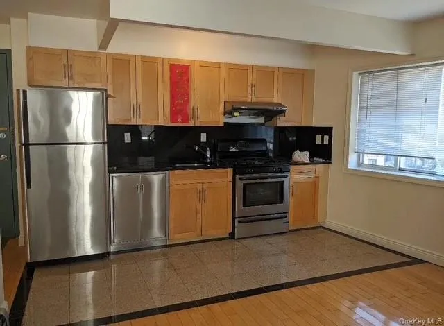 a kitchen with stainless steel appliances a refrigerator sink and stove