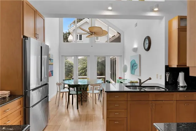 a kitchen with stainless steel appliances granite countertop a refrigerator and a sink