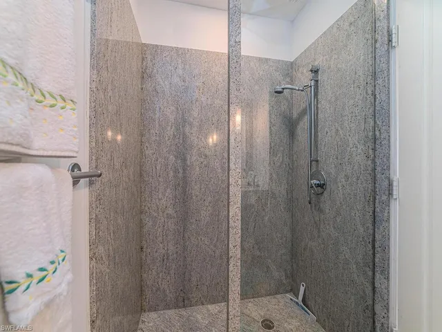 a bathroom with a shower and a sink