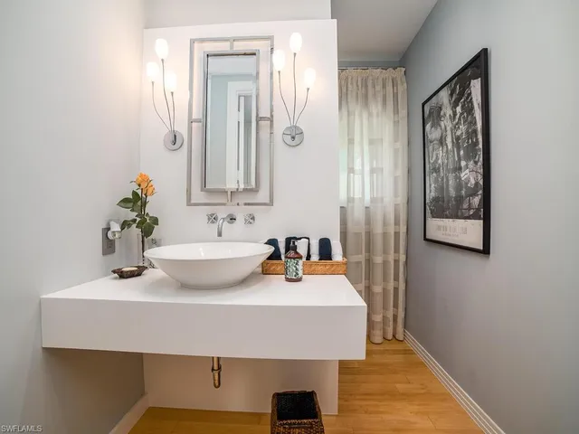 a view of a bathroom with sink and mirror