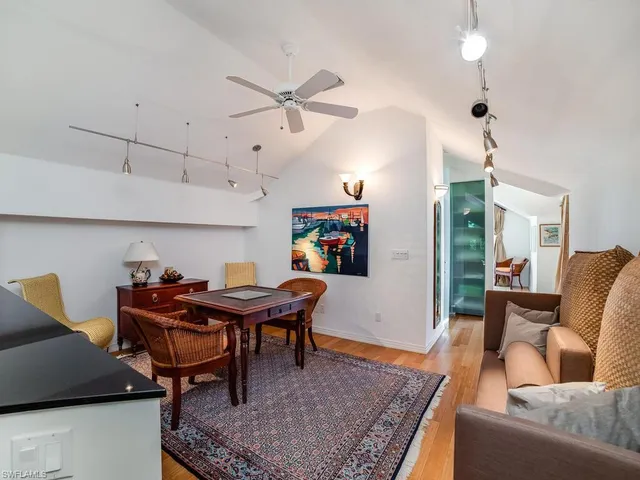 a living room with furniture a rug and a chandelier