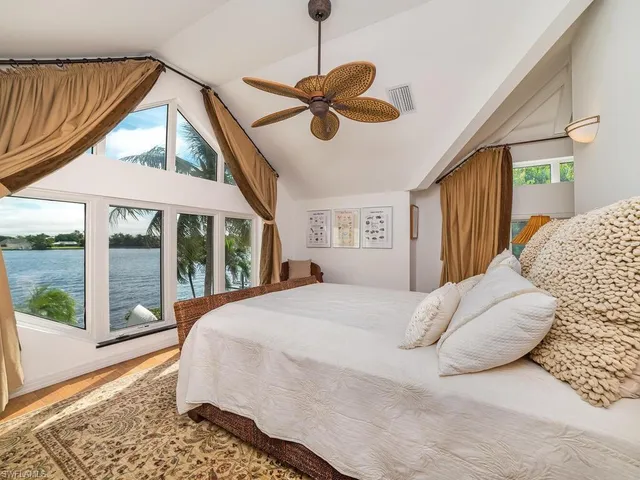 a bedroom with a large bed and a large window