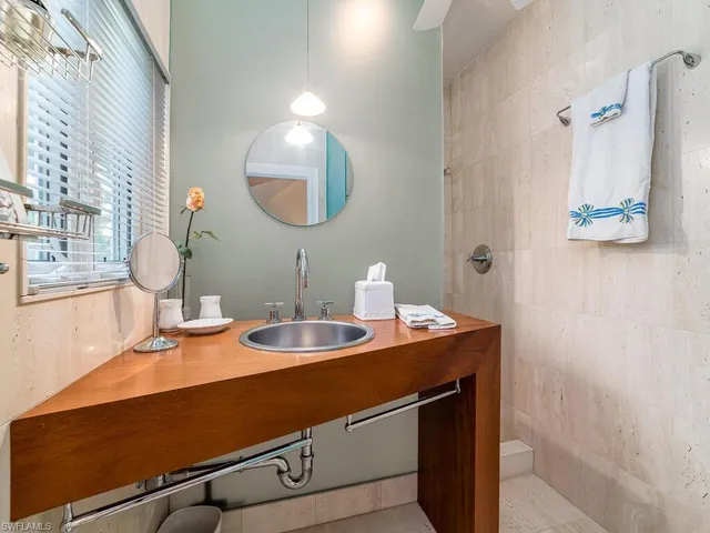 a room with a sink and a mirror