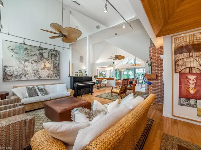 a living room with furniture a table and chairs