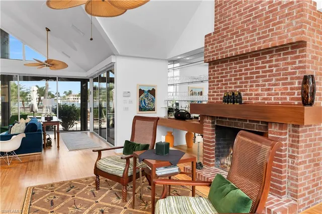 a living room with furniture and floor to ceiling windows