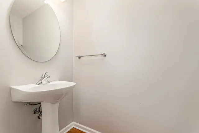 a bathroom with a sink a mirror and vanity