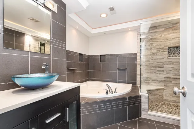 a bathroom with a bathtub and shower