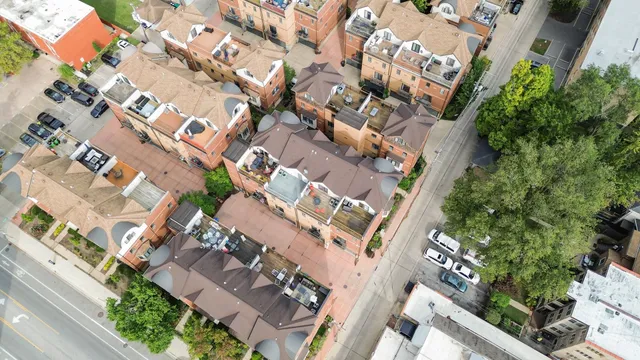 an aerial view of multiple houses with yard