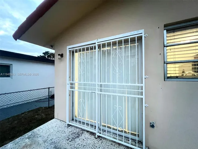 a view of staircase with white walls and a window