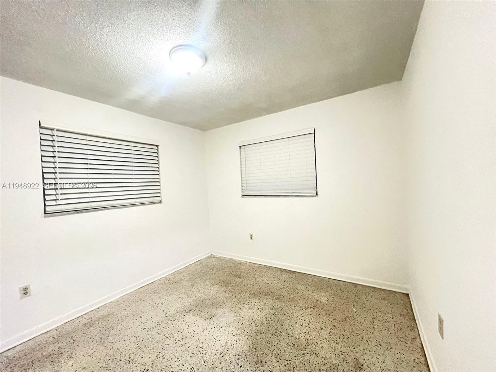 2762 Southwest 21st Street Miami, FL 33145 - Photo 8 of 14 an empty room with a window