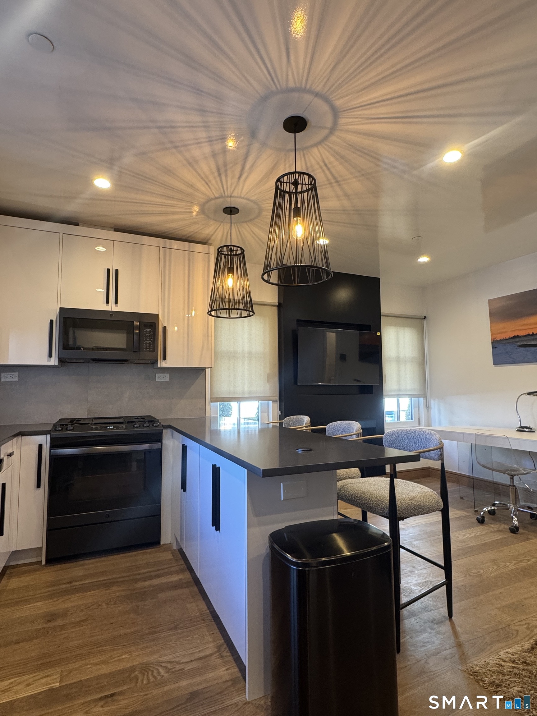 930 Cove Road, Unit 2 Stamford, CT 06902 - Photo 2 of 14 a kitchen with stainless steel appliances kitchen island granite countertop a stove and a sink