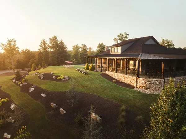 a view of house with outdoor space and seating area