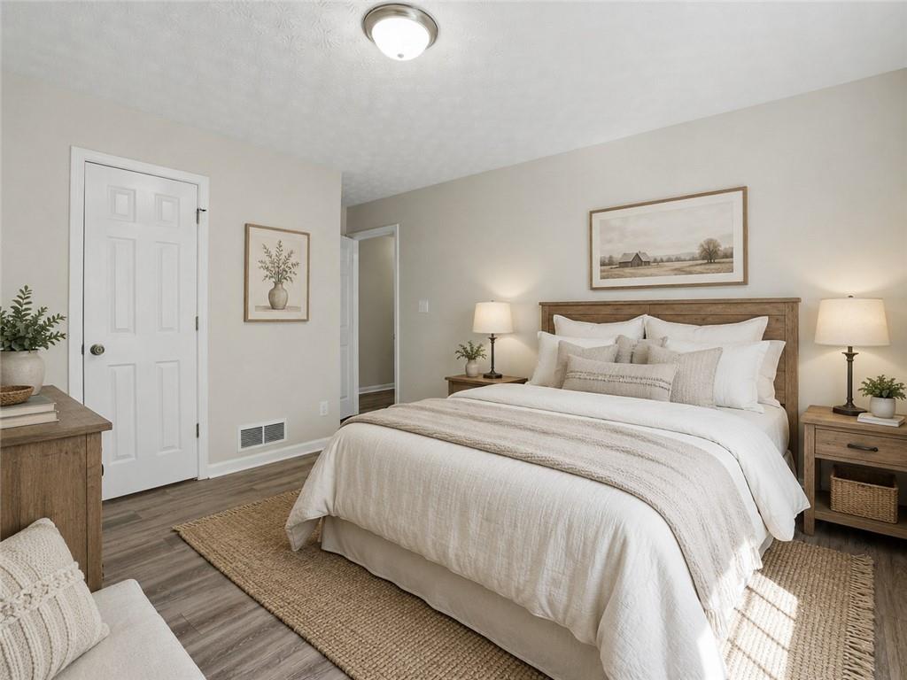 314 Coady Road Jackson, GA 30233 - Photo 12 of 31 a bedroom with a bed and painting on the wall