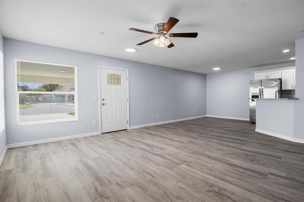 4078 Oak Loop Mulberry, FL 33860 - Photo 3 of 19 a view of an empty room with a window and wooden floor