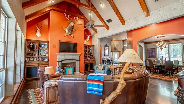 a living room with fireplace furniture and a flat screen tv