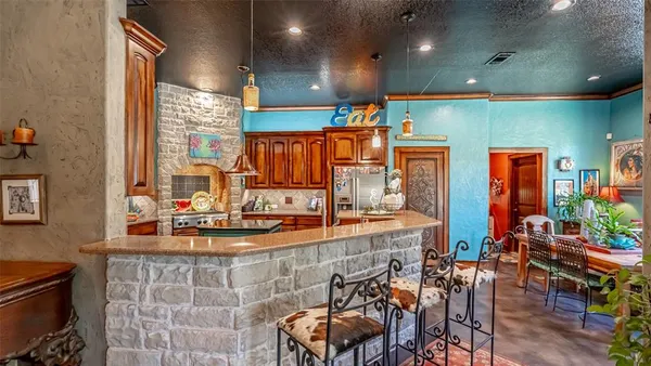 a kitchen with stainless steel appliances dining table and chairs