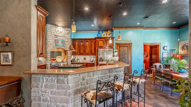 a kitchen with stainless steel appliances dining table and chairs
