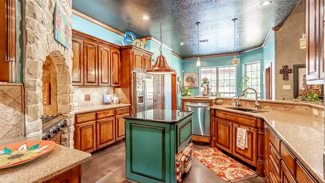 a kitchen with stainless steel appliances granite countertop a stove and a sink