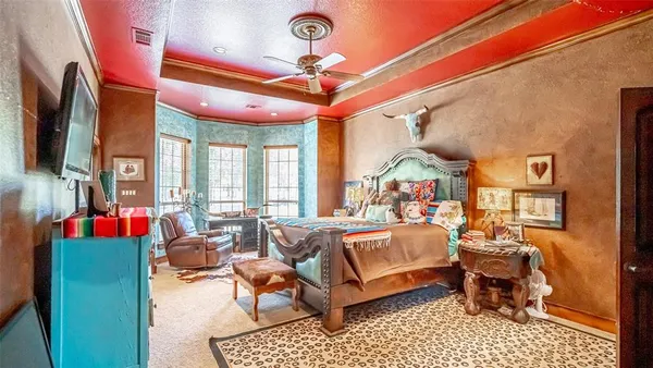 a bedroom with furniture and a large window