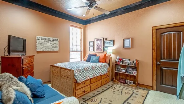 a bedroom with a bed and a chandelier