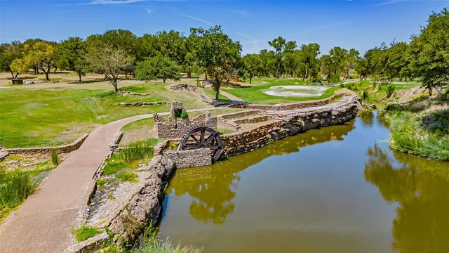 a view of a lake with a yard and trees