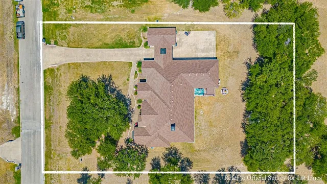 an aerial view of a house with a yard
