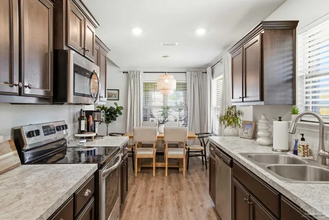 a stove top oven sitting inside of a kitchen