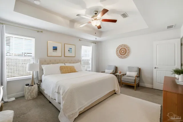 a bedroom with a bed window and a flat screen tv