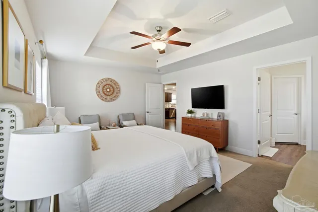 a bedroom with a bed a window and a flat screen tv