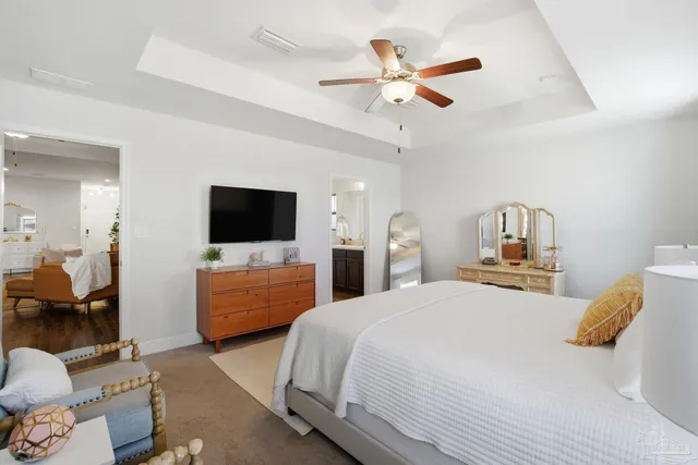 a bathroom with a granite countertop sink a toilet and a mirror