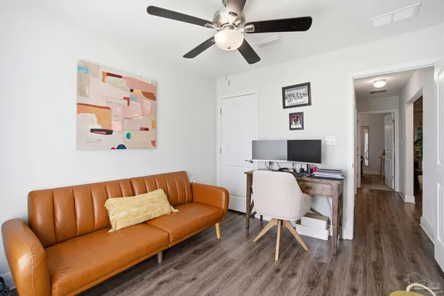 a bedroom with a bed a chandelier and a window