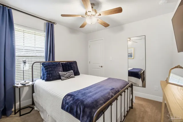 a bedroom with a large bed and a chandelier