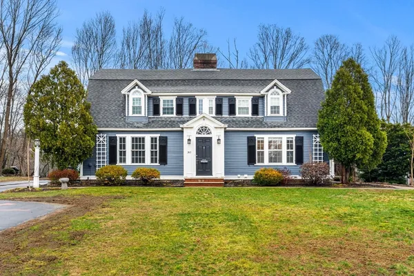 a front view of house with yard and green space