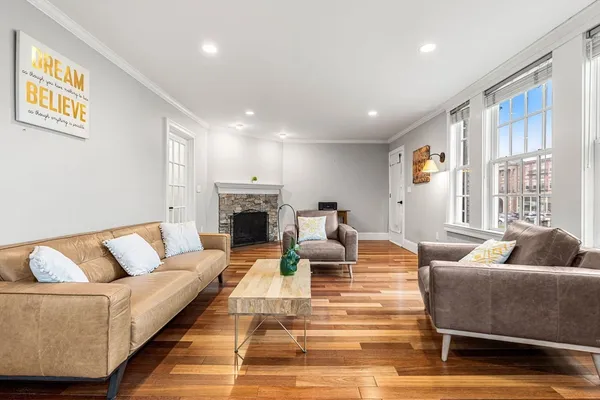 a living room with furniture and a fireplace