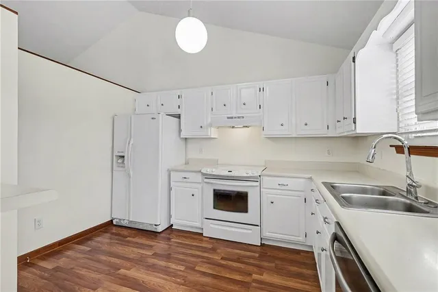 a view of hallway with furniture and wooden floor