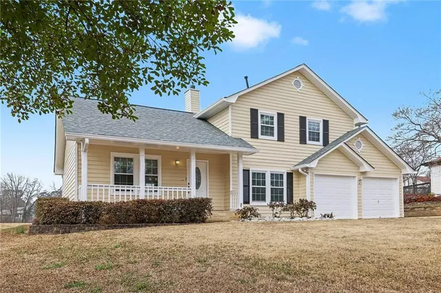a front view of a house with a yard