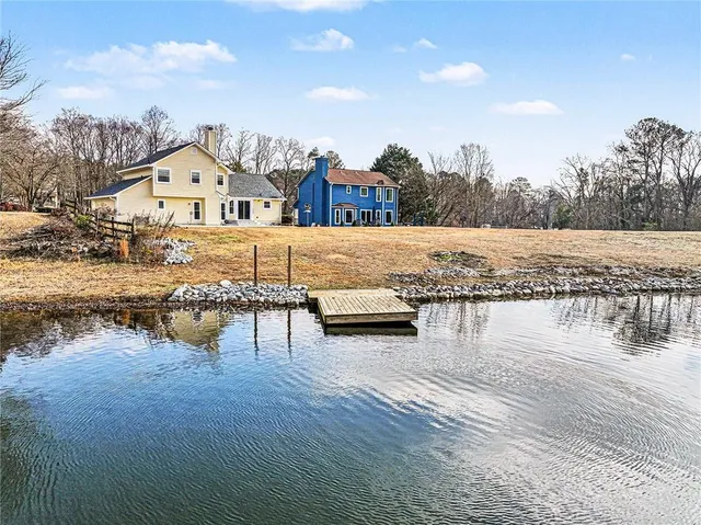 a view of house with outdoor space and lake view
