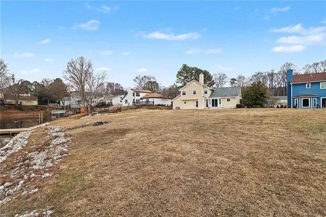 a view of a dry yard with trees