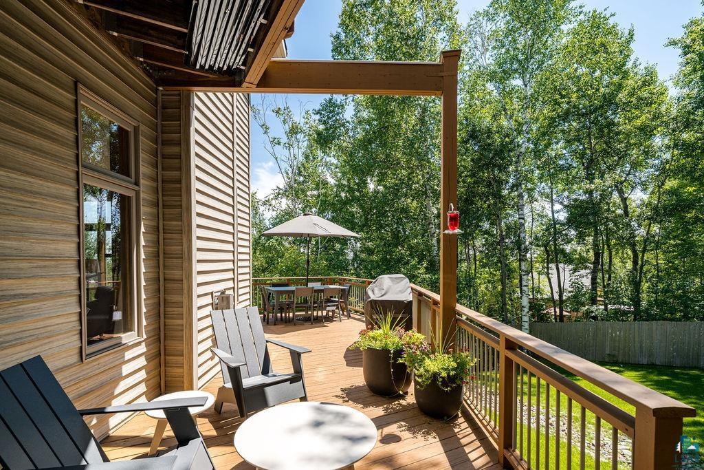 4856 Kingston Street Duluth, MN 55804 - Photo 74 of 88 Expansive wood-finish deck with integrated railing, offering multiple zones for outdoor living