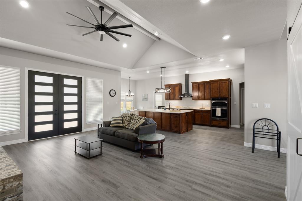 1404 Faulkner Road Sunset, TX 76270 - Photo 14 of 40 Living area featuring recessed lighting, light wood-style floors, ceiling fan, french doors, and high vaulted ceiling
