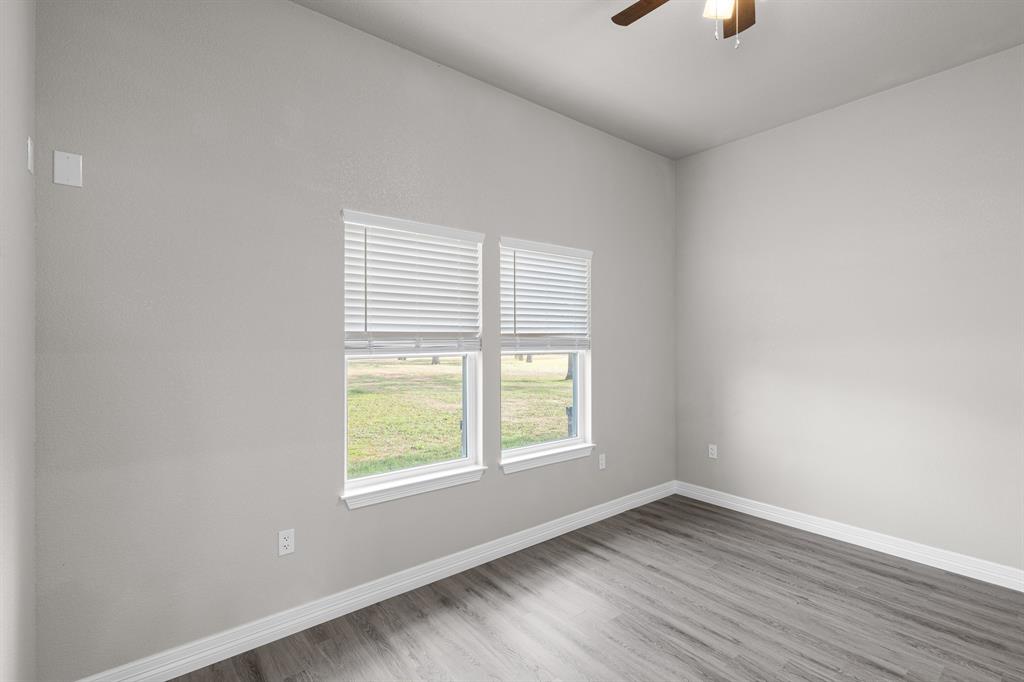 1404 Faulkner Road Sunset, TX 76270 - Photo 29 of 40 Unfurnished room featuring ceiling fan and wood finished floors