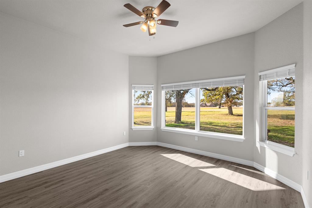 1404 Faulkner Road Sunset, TX 76270 - Photo 33 of 40 Empty room featuring dark wood-style flooring and ceiling fan