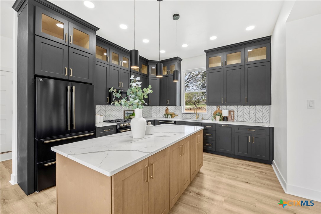 108 Skyline Road Georgetown, TX 78628 - Photo 15 of 48 a large kitchen with kitchen island a sink stainless steel appliances and cabinets