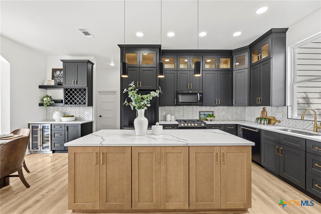 108 Skyline Road Georgetown, TX 78628 - Photo 2 of 48 a kitchen with stainless steel appliances kitchen island granite countertop a sink and cabinets