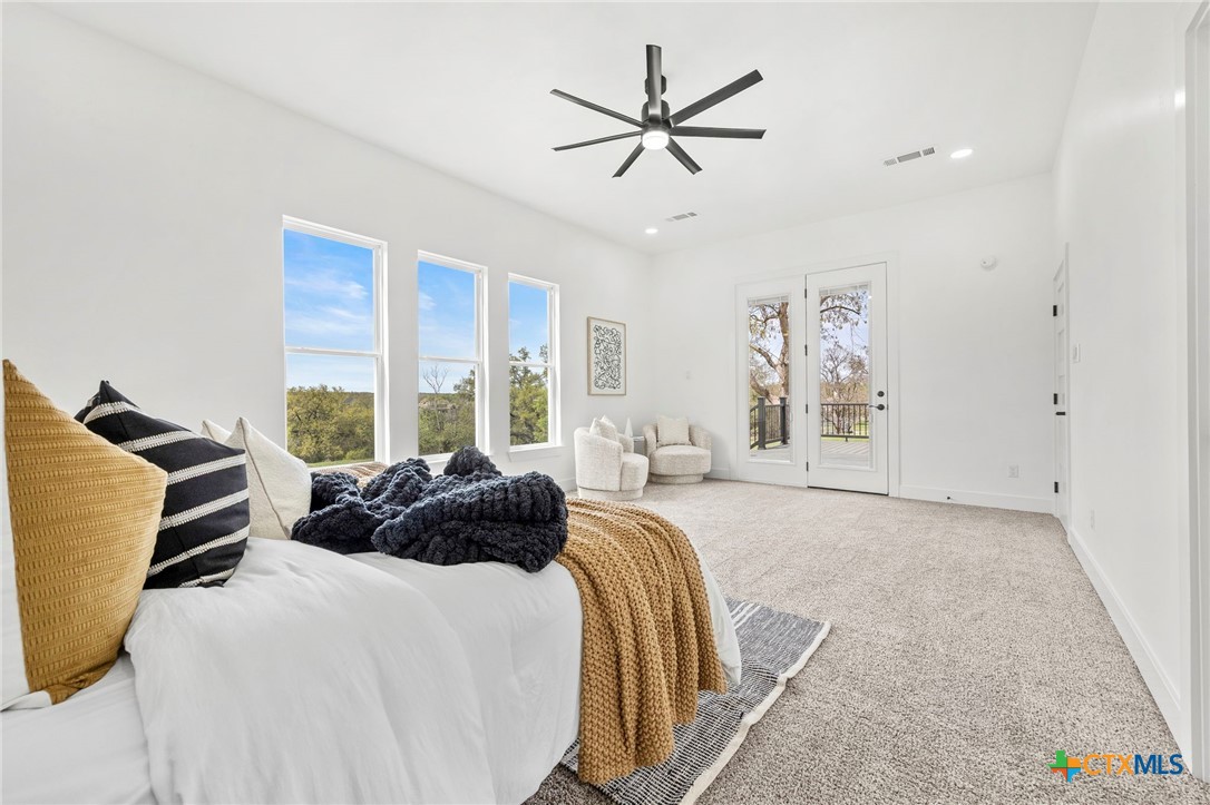 108 Skyline Road Georgetown, TX 78628 - Photo 21 of 48 a bedroom with a bed a large window and couch